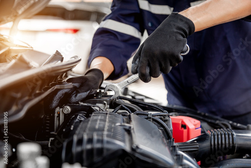 Car care maintenance and servicing, Close-up hand technician auto mechanic using the wrench to repairing change spare part car engine problem and insurance service support.