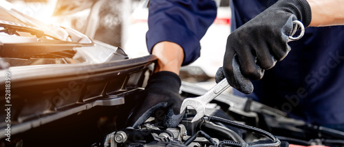 Car care maintenance and servicing, Close-up hand technician auto mechanic using the wrench to repairing change spare part car engine problem and insurance service support.