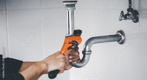 plumber at work in a bathroom, plumbing repair service, assemble