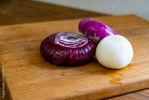 red and white onions on a wooden cutting board