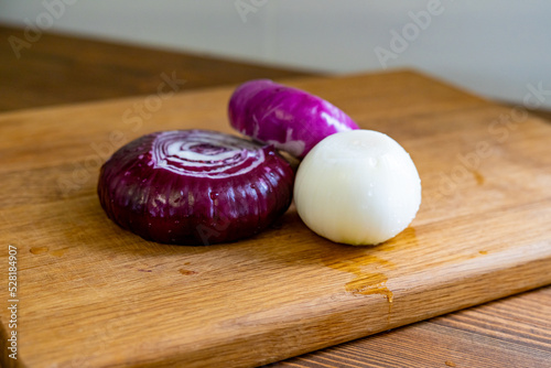 red and white onions on a wooden cutting board