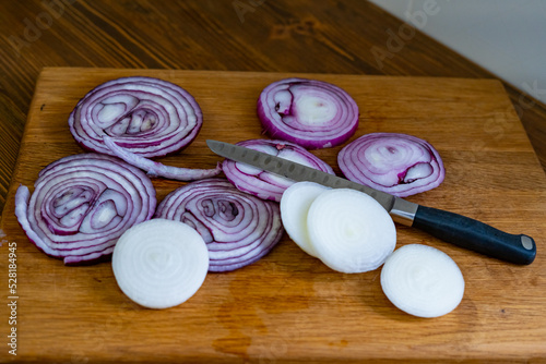sliced onions on a wooden cutting board