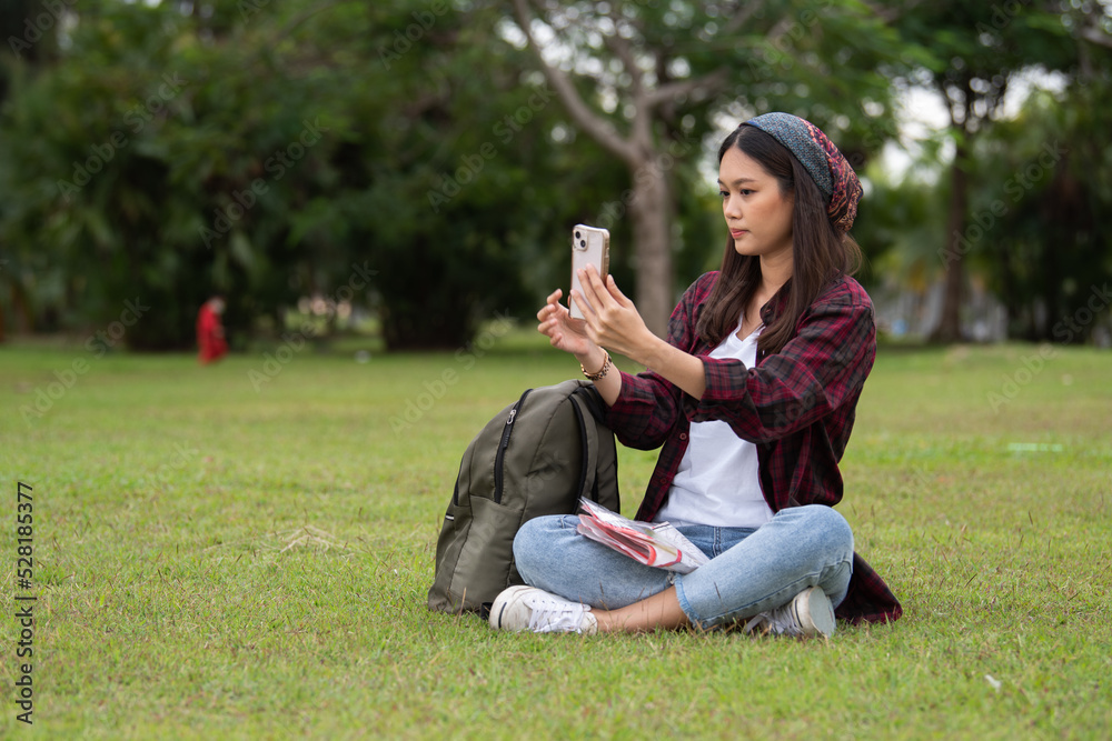 A beautiful Asian tourist using a camera while traveling A beautiful Asian tourist using a camera while traveling