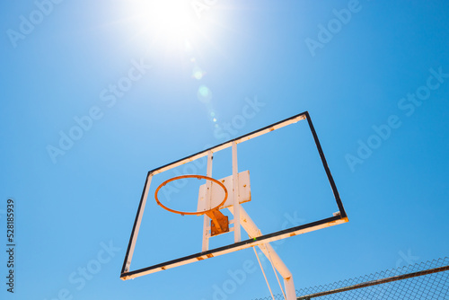Broken backboard of basketball field in the park. Abandoned town concept photo