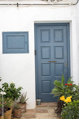 Picturesque blue door in the town of Frigiliana located in mountainous region of Malaga, 