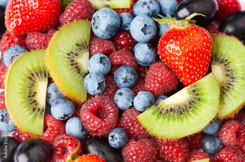 Fototapeta Naklejka Na Ścianę i Meble -  Fruits. Background of sweet berries and kiwi. Fresh fruit closeup.