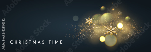 Christmas bokeh light effect with gold sowflakes.