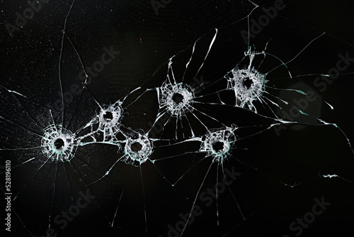 bullet hole on glass black background for overlay, transparent window photo