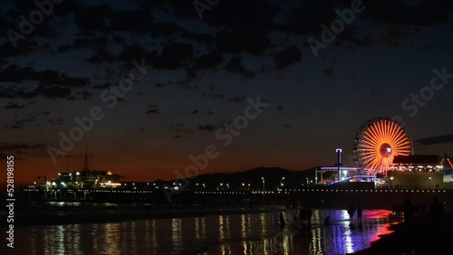 Timelapse capturing the clouds and moving objects and lights of Santa Monica Pier