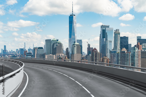 Empty urban asphalt road exterior with city buildings background. New modern highway concrete construction. Concept of way to success. Transportation logistic industry fast delivery. New York. USA.