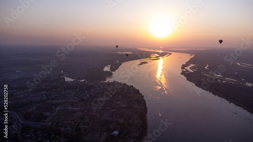 Drone aerial view of hot air balloons over the Volga river in the Kostroma region at sunset. travel background