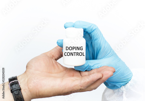 Doping Control text on the label of a white drug jar, the doctor passes the jar to the patient's hand on a white background