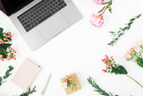 Gray laptop with roses, and copy space on white background. Flat lay. Top view
