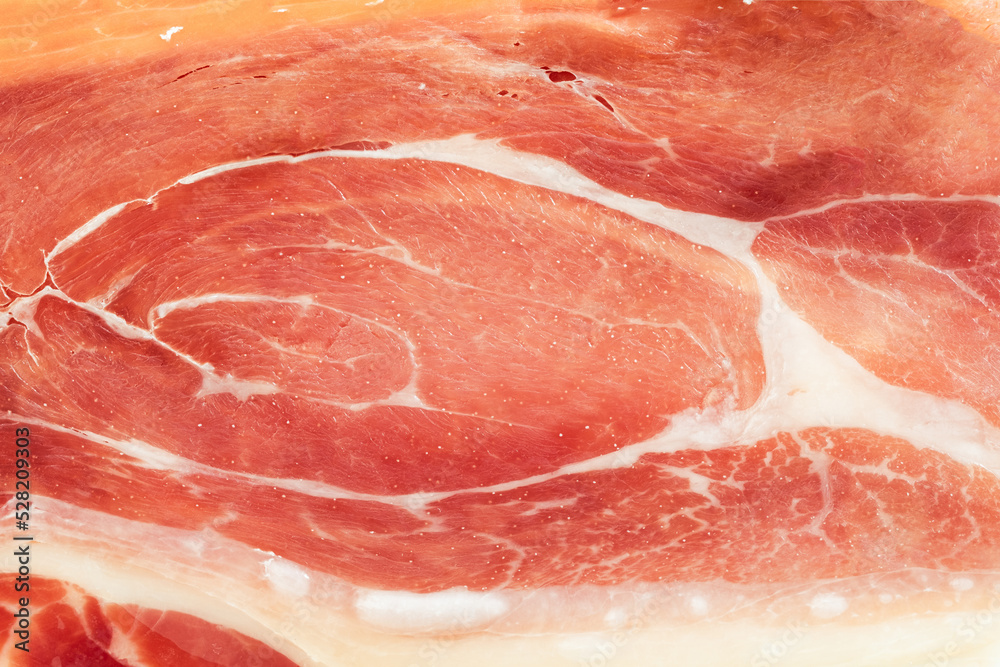 Slices of dried spanish ham. Jamon Serrano. Flat lay. Close up of meat slice. Meat textured background Slices of dried spanish ham. Jamon Serrano. Flat lay. Close up of meat slice. Meat textured background