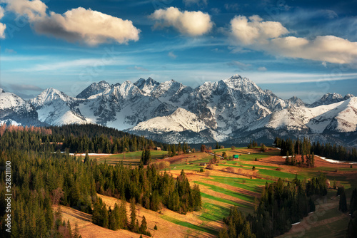 View of the Tatra Mountains, meadows, pastures, from Gliczarów Górny. Spring, Poland. Widok na Tatry, góry, łąki, hale, z Gliczarowa Górnego. Wiosna, Podhale, Polska. Krajobraz