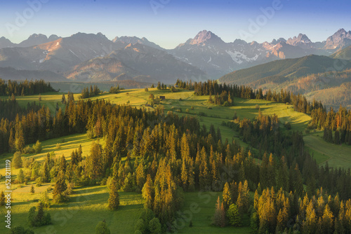View of the Tatra Mountains, meadows, pastures, from Gliczarów Górny. Spring, Poland. Widok na Tatry, łąki, hale, z Gliczarowa Górnego. Wiosna, Podhale, Polska. Krajobraz