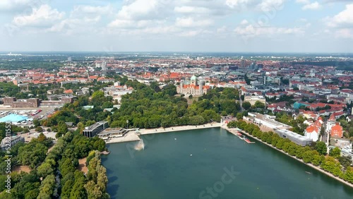 New Town Hall (Neues Rathaus) and Hannover city center aerial view, Germany, Europe. Aircraft point of view aerial shot ft. Maschsee Lake and parks around Hanover-Mitte, the historic heart of the city