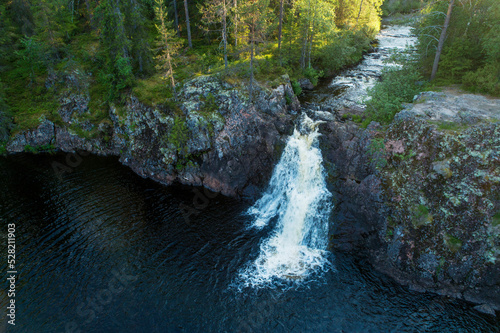 Fototapeta Naklejka Na Ścianę i Meble -  Beautiful Komulanköngäs waterfall on a summer evening. Shot near Hyrynsalmi, Northern Finland. 