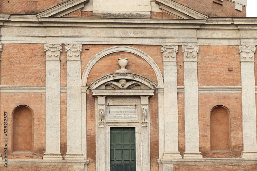 Santa Maria di Loreto Church Facade Close Up with Sculpted Details and Wooden Entrance in Rome, Italy Santa Maria di Loreto Church Facade Close Up with Sculpted Details and Wooden Entrance in Rome, Italy