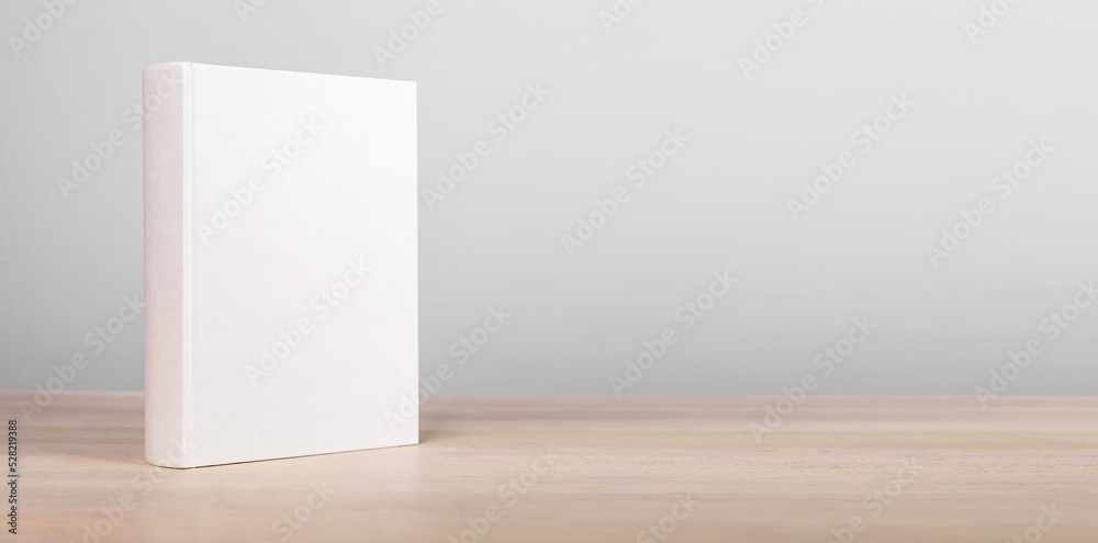 Banner with book mockup standing at wooden table. Novel, encyclopedia, code template with empty cover. Reading leisure, education, learning new information concept. Copy space Banner with book mockup standing at wooden table. Novel, encyclopedia, code template with empty cover. Reading leisure, education, learning new information concept. Copy space