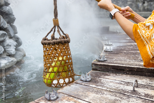 Cook corn and egg inside basket in hot spring at Jioujhihze of Taipingshan in Taiwan photo