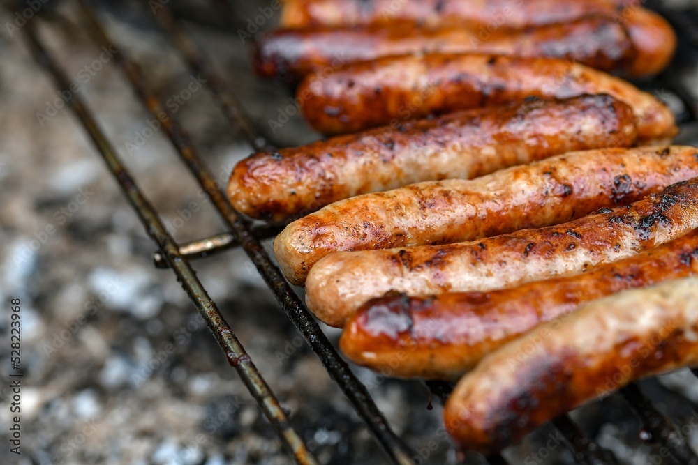 Grilled sausages on the fire are on the grill and are ready to eat.