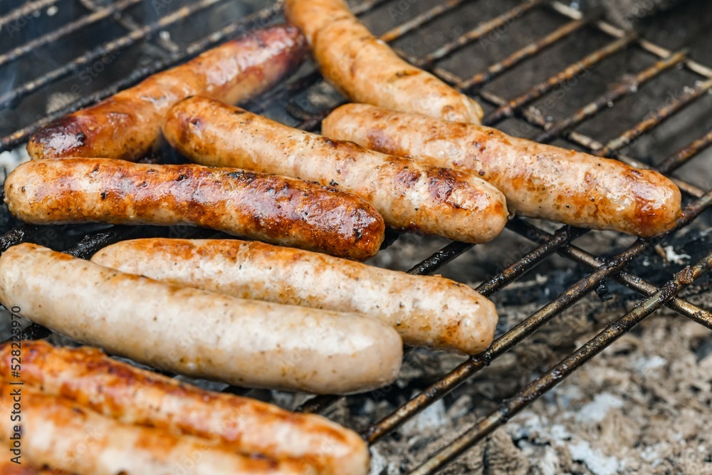 Grilled juicy sausages cooked on a campfire outdoors. Grilled juicy sausages cooked on a campfire outdoors.