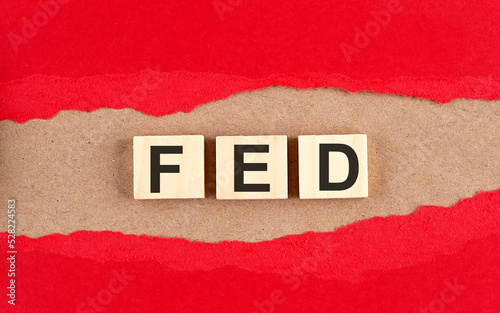 FED word on wooden cubes on red torn paper , financial concept background