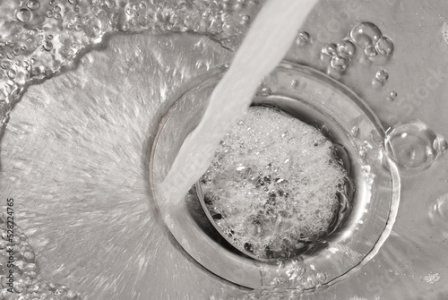 Detail of water jet falling down a drain