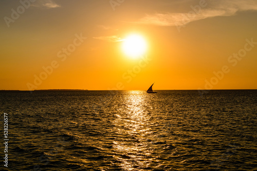 Traditional sail boat dhow at the Indian ocean when sunset