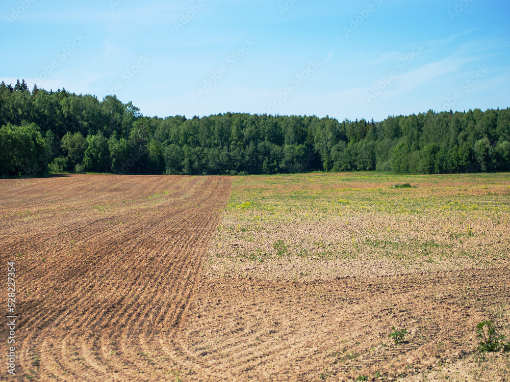 half plowed field, farming and farming concept