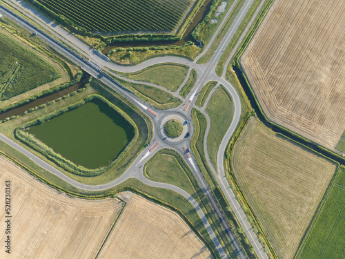 Roundabout junction aerial vehicle auto motorway intersection. Transportation safety crossroad. Circular ring road infrastructure street. Aerial drone overview.