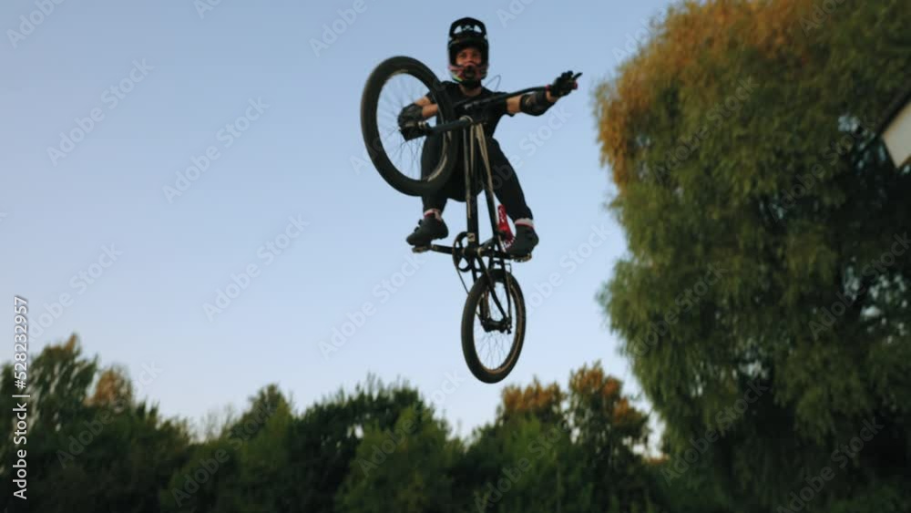amazing bike trick on track, bicyclist is flying against sky, BMX stunt bicycle, flight of biker amazing bike trick on track, bicyclist is flying against sky, BMX stunt bicycle, flight of biker