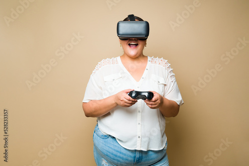 Excited plus size woman gaming and playing virtual reality video games