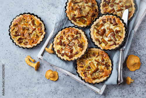 chanterelle tarts or quiches on grey concrete background