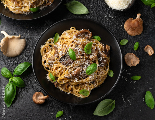 Porcini and woodland mushrooms pasta with pecorino cheese, basil in black bowl