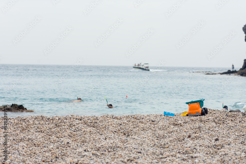 Playa de Los Muertos in Spain, children toys on the sand Playa de Los Muertos in Spain, children toys on the sand