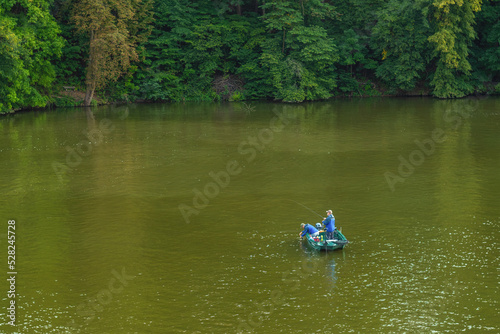 Quadro su tela Fishermen in a boat catch fish on the dam.