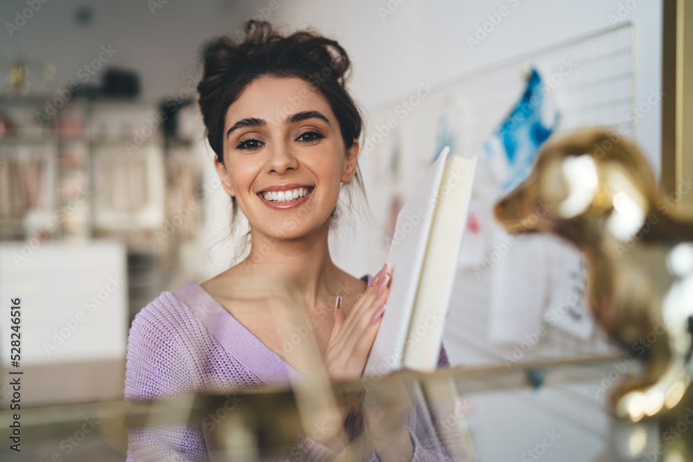 Gentle sweet girl in purple sweater posing at camera smiling sincerely from. Radiant brunette woman with beautiful appearance holds diary in hands. Positive female student with notebook organizer Gentle sweet girl in purple sweater posing at camera smiling sincerely from. Radiant brunette woman with beautiful appearance holds diary in hands. Positive female student with notebook organizer