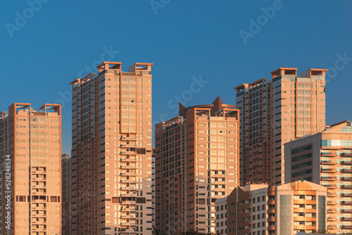 New Residential Multi-storey Houses. Cityscape Skyline In Sunny Spring Evening On Blue Sky. Real Estate, Development Industry. UAE.