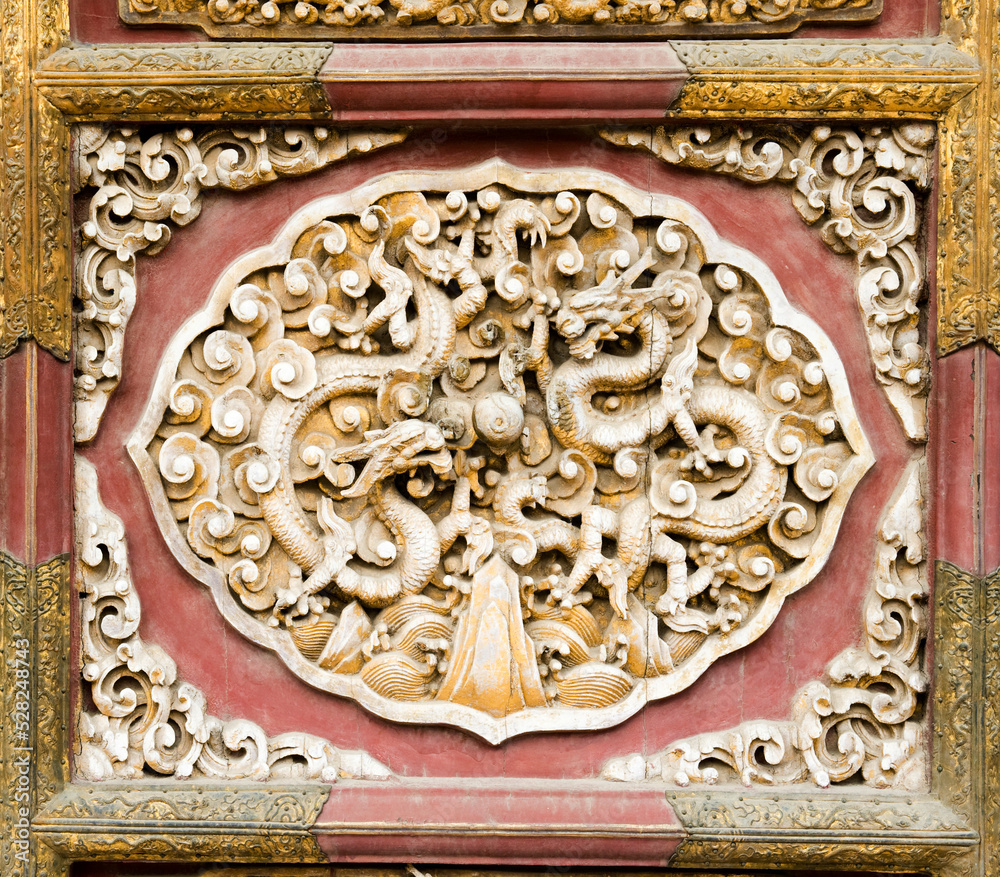 Exquisite wood carving art on the door of the Palace of the Forbidden City in Beijing, China