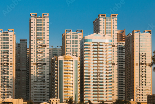 New Residential Multi-storey Houses. Cityscape Skyline In Sunny Spring Evening On Blue Sky. Real Estate, Development Industry. UAE.