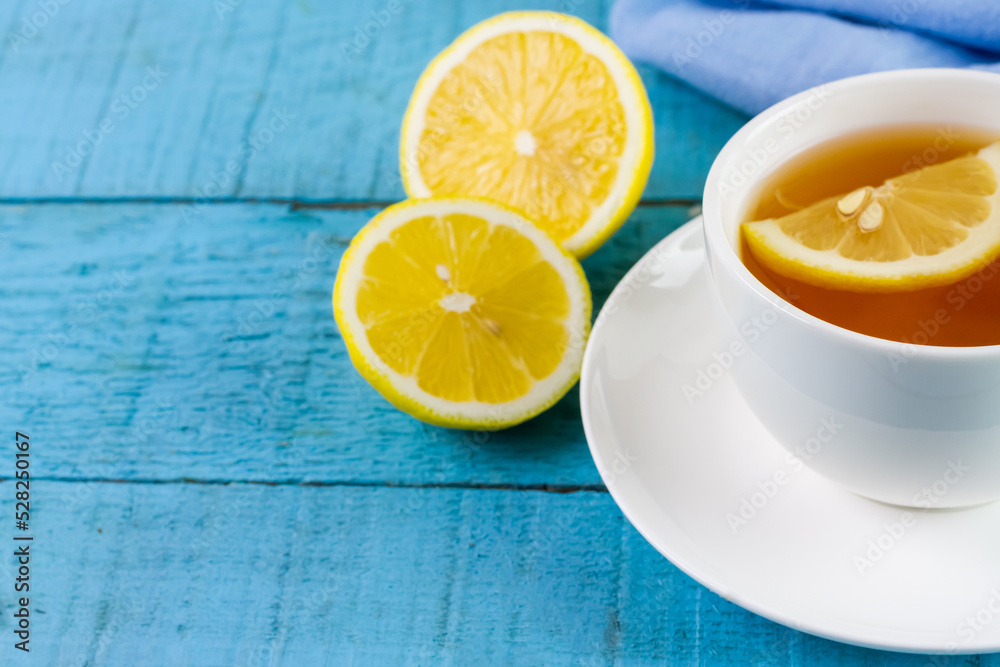 Cup of hot tea and lemon on blue wooden table. Cup of hot tea and lemon on blue wooden table.