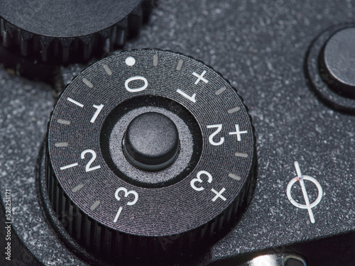 manual exposure compensation dial on a camera with one third increments to three stops. photo