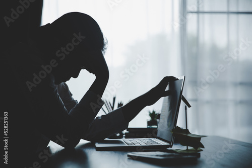 Stress business woman person from hard work, depression in office. Tired and anxious employee female with unhappy at problem job. young businesswoman sitting sad front of laptop computer on desk.