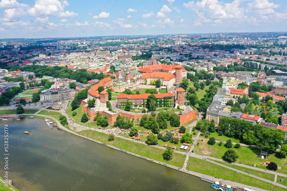 Fototapeta premium Wawel Castle in Krakow on a cloudy summer day. Old town in the background.