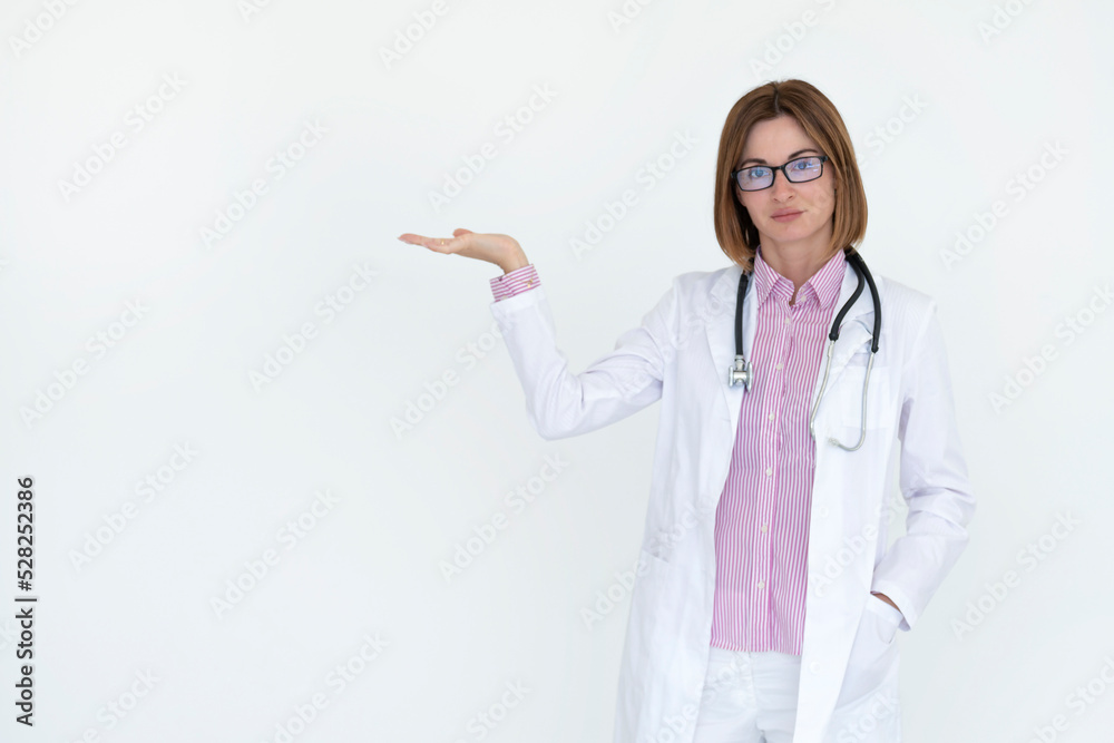 Female doctor standing and pointing on free space isolated on white background Female doctor standing and pointing on free space isolated on white background