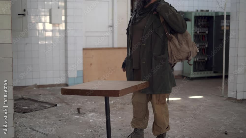 Post apocalypse, dirty man in ruined building cooking food, problem of getting food and water, survivor in apocalyptic world Post apocalypse, dirty man in ruined building cooking food, problem of getting food and water, survivor in apocalyptic world