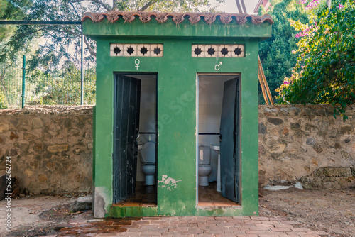 Old, open, public toilet in a park