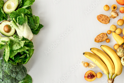 A variety of fresh vegetables and fruits on a white background, flat lay.